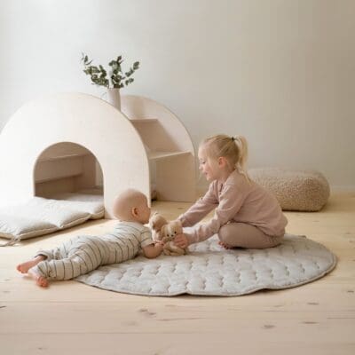 A baby and a child playing on PILVI play mat